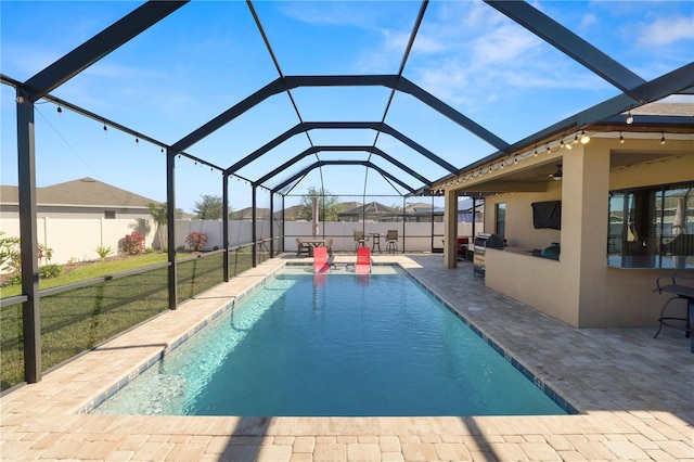 view of pool with a yard, a patio, area for grilling, and a lanai