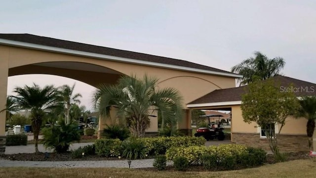 back of property featuring a carport