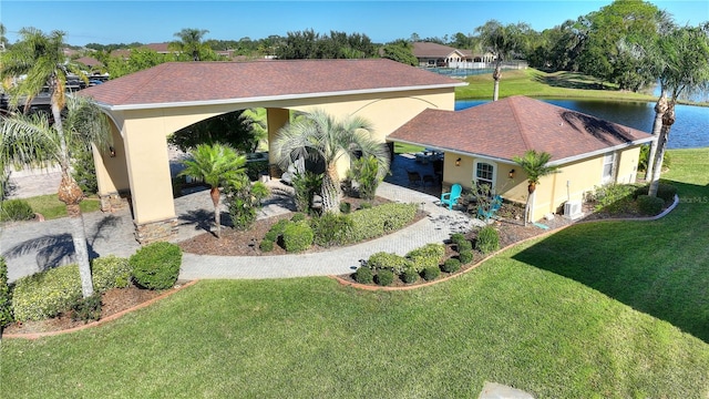 exterior space with a water view and a front yard