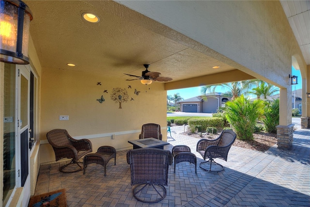 view of patio / terrace with ceiling fan and an outdoor fire pit