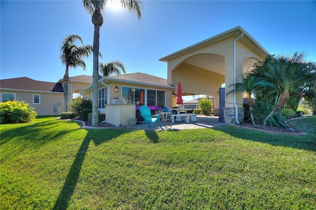 back of house featuring a yard and a patio