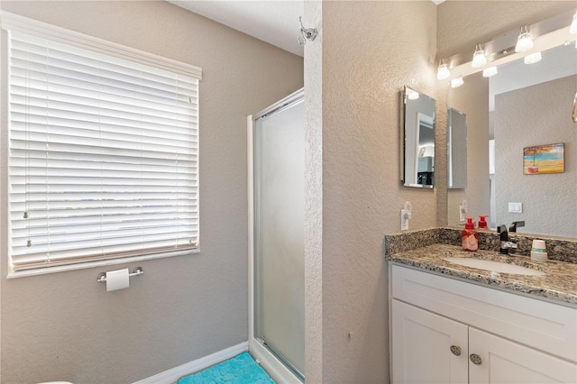 bathroom featuring vanity and an enclosed shower