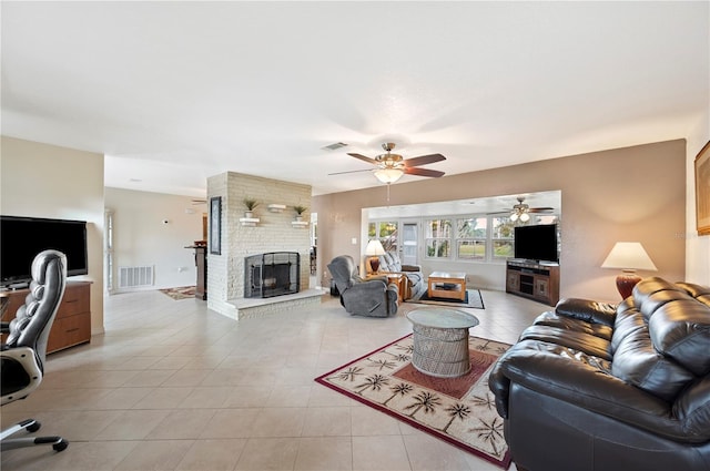 living room with ceiling fan, light tile patterned floors, and a fireplace