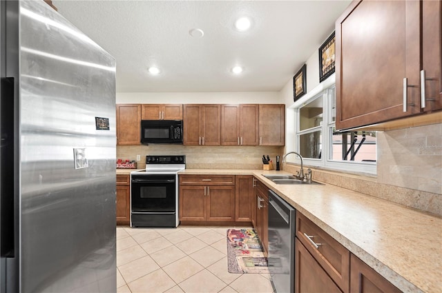 kitchen with backsplash, sink, light tile patterned floors, and appliances with stainless steel finishes