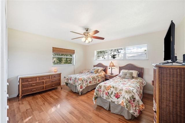 bedroom with ceiling fan and light hardwood / wood-style floors