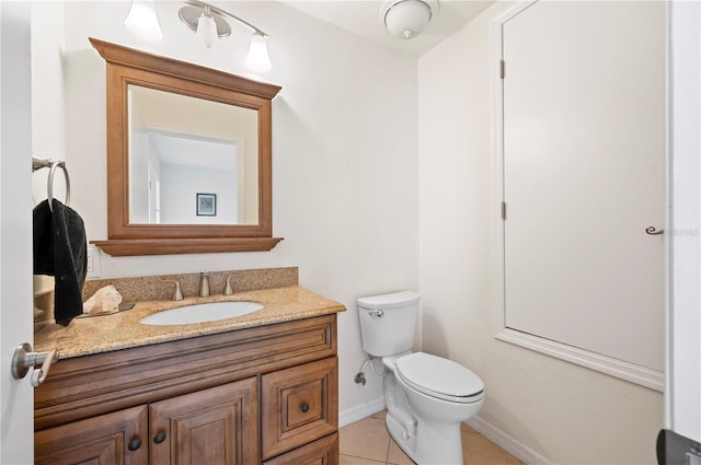 bathroom with tile patterned flooring, vanity, and toilet