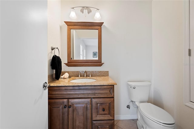 bathroom featuring tile patterned flooring, vanity, and toilet