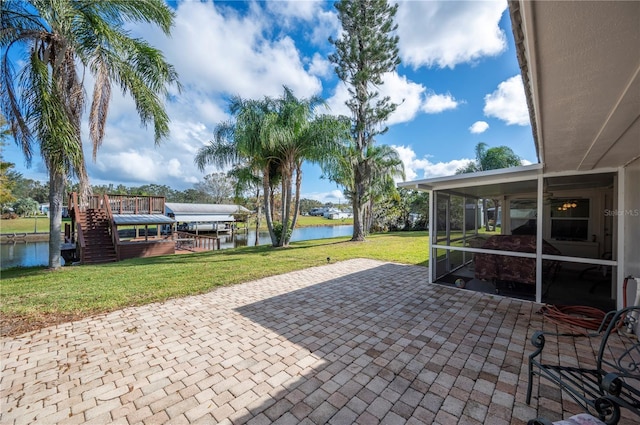 view of patio / terrace with a sunroom and a water view