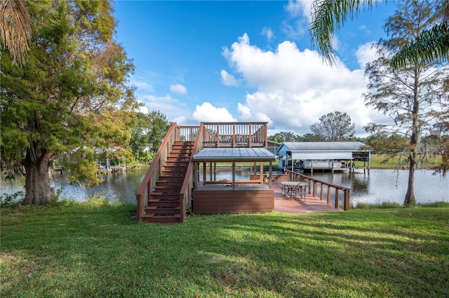 dock area with a lawn and a water view