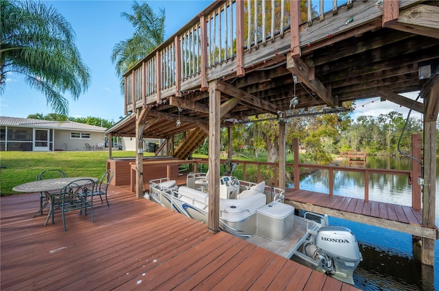 deck featuring a water view and a lawn