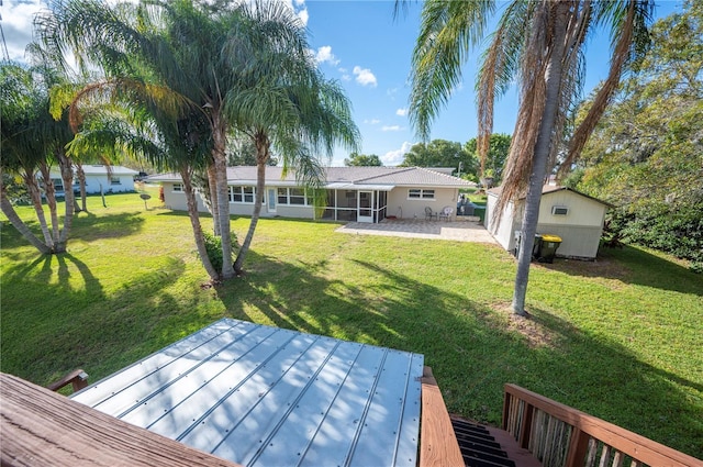 view of yard featuring a wooden deck and a sunroom