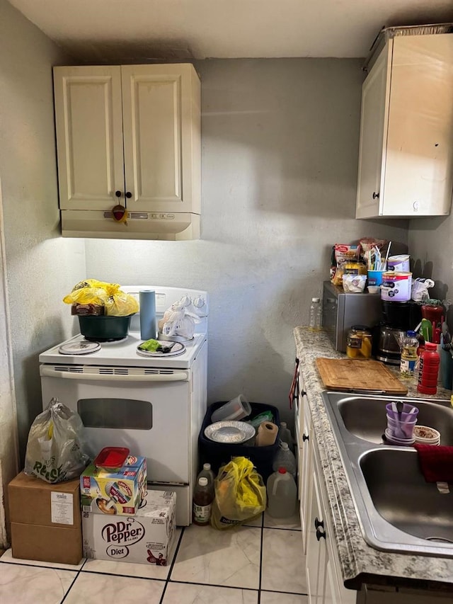 kitchen featuring white cabinets, white electric range, and sink