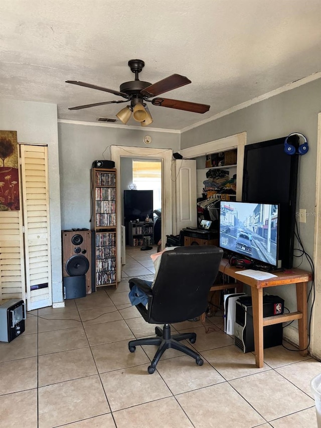 office space with crown molding, light tile patterned floors, a textured ceiling, and ceiling fan