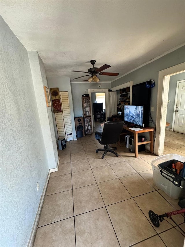 tiled office with ceiling fan and crown molding