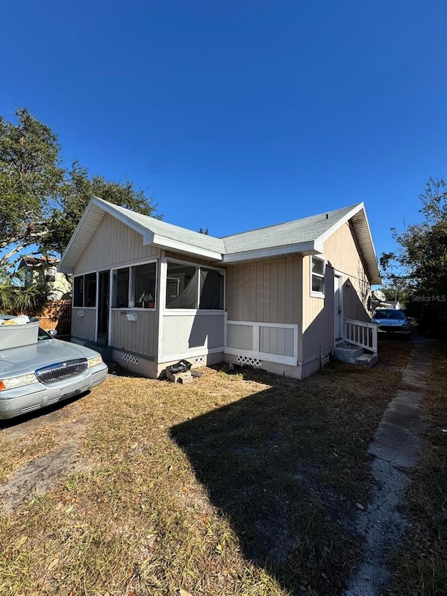 view of front of house with a sunroom