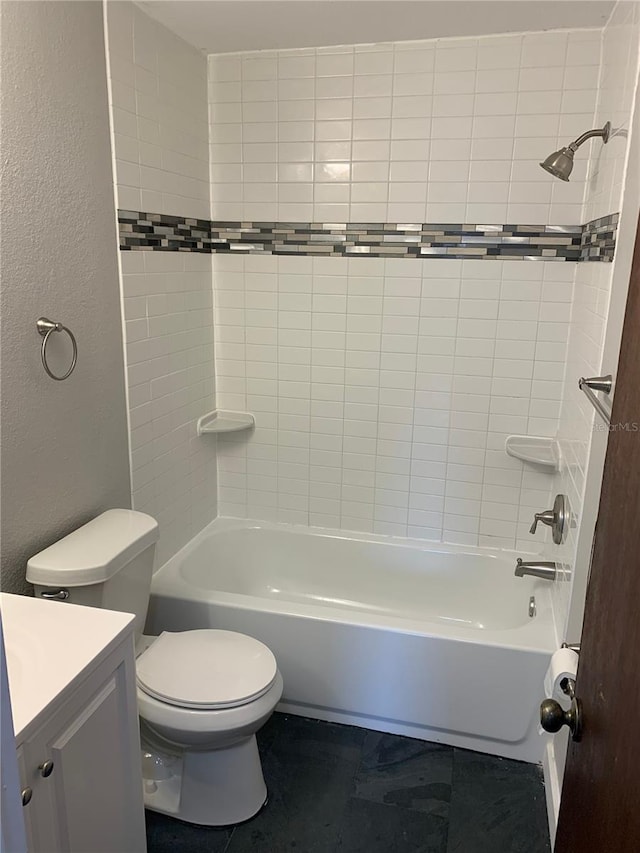 full bathroom with vanity, toilet, and tiled shower / bath combo