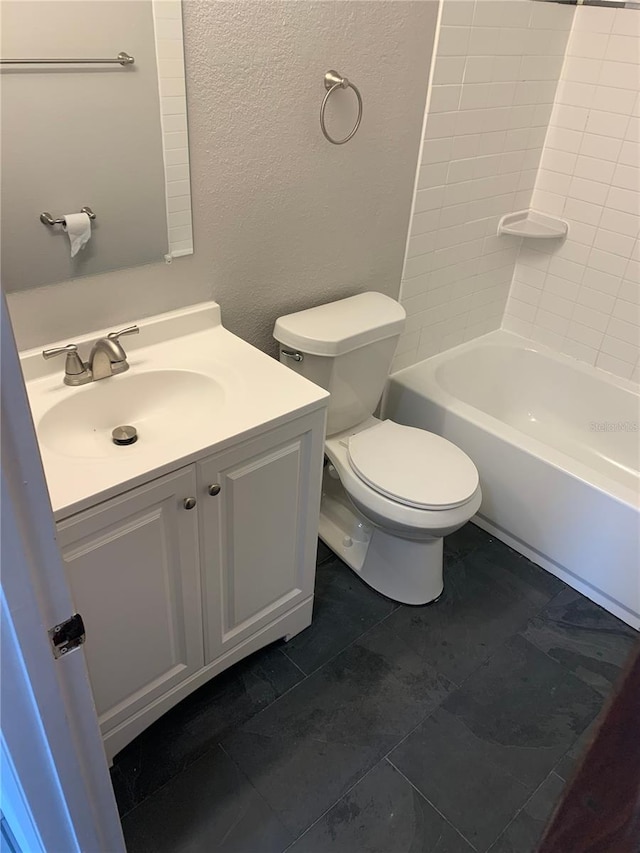 full bathroom with tile patterned flooring, vanity, bathtub / shower combination, and toilet