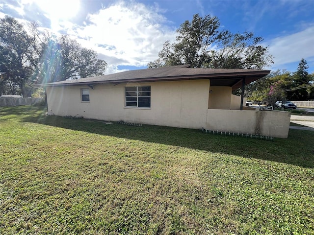 view of home's exterior featuring a yard