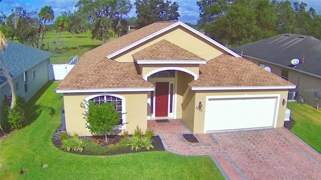 view of front of house with a garage and a front lawn