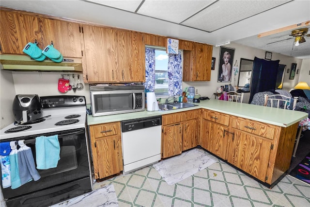 kitchen featuring ceiling fan, sink, dishwasher, black range with electric cooktop, and kitchen peninsula