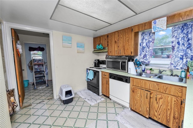 kitchen with dishwasher, black electric range, plenty of natural light, and sink