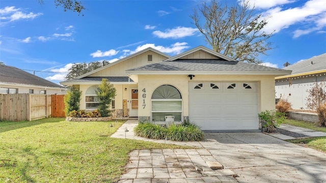 view of front of house with a garage and a front lawn