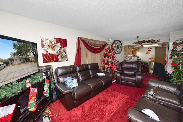 carpeted living room featuring a textured ceiling