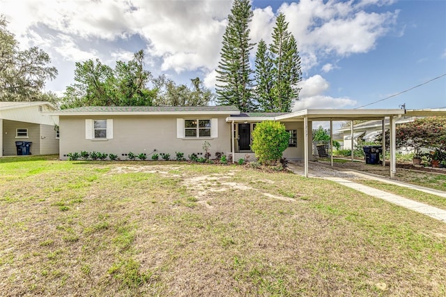 view of front facade with a front yard and a carport