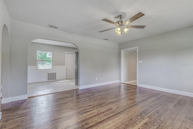 spare room with hardwood / wood-style floors and ceiling fan