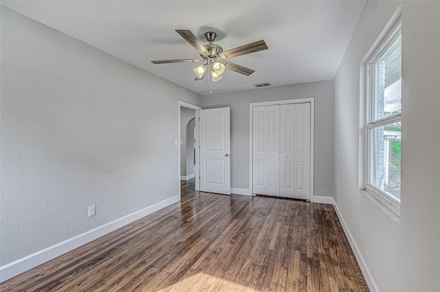 unfurnished bedroom featuring ceiling fan, a closet, and dark hardwood / wood-style floors