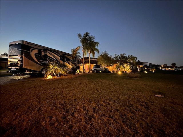 view of yard at dusk