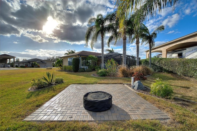 view of patio featuring a fire pit and a lanai