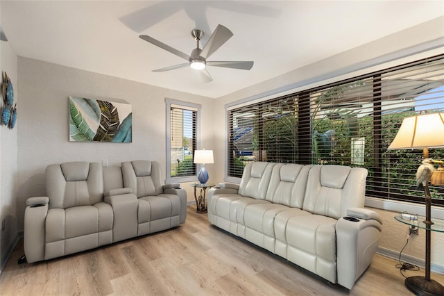 living room featuring ceiling fan and light wood-type flooring