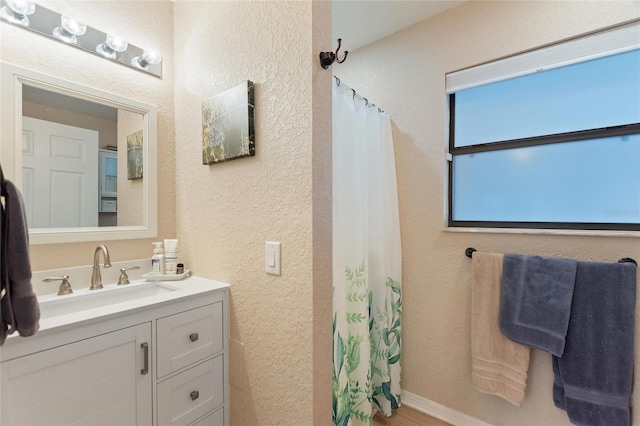 bathroom featuring vanity and walk in shower