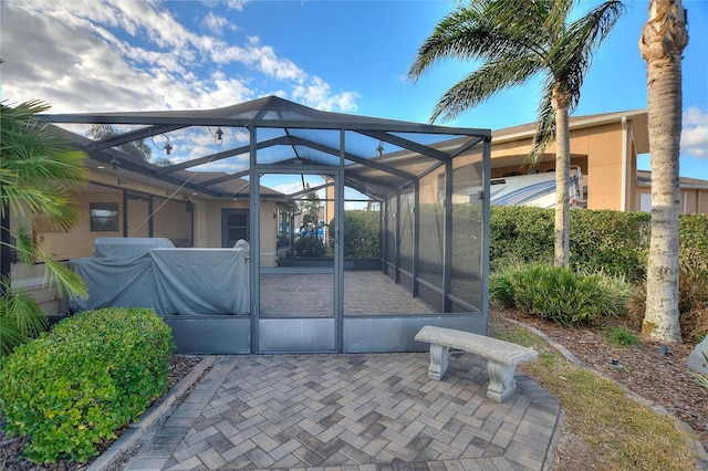 view of patio / terrace featuring a lanai