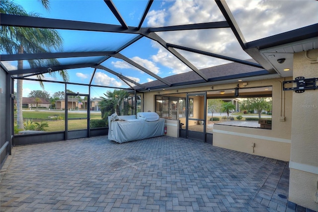 unfurnished sunroom featuring plenty of natural light and vaulted ceiling