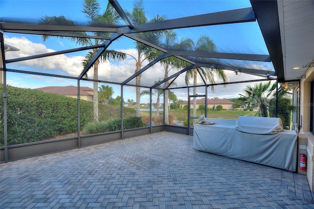 view of patio / terrace featuring glass enclosure