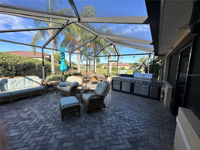 view of patio / terrace featuring area for grilling, a lanai, and exterior kitchen
