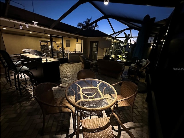 patio terrace at dusk featuring glass enclosure