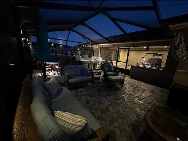 view of patio with outdoor lounge area and glass enclosure