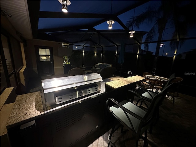 view of patio / terrace with area for grilling, glass enclosure, and an outdoor bar