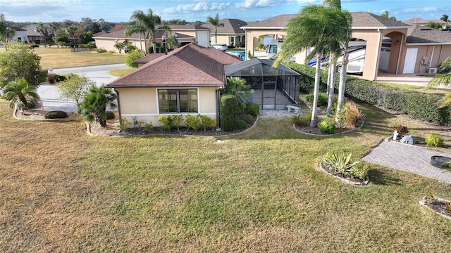 view of front facade with a lanai and a front lawn