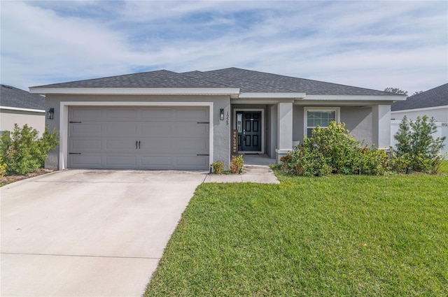 view of front facade featuring a garage and a front lawn