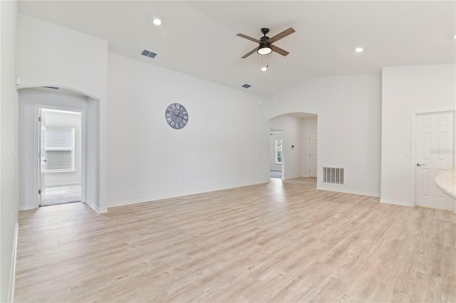 unfurnished room with high vaulted ceiling, light hardwood / wood-style floors, and ceiling fan