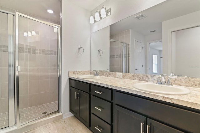 bathroom featuring vanity and an enclosed shower