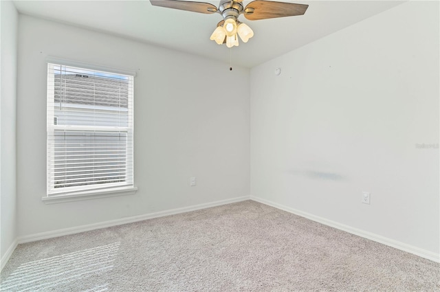 carpeted spare room with ceiling fan