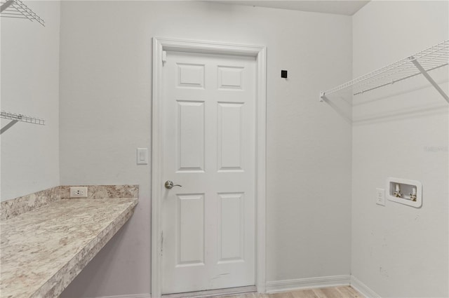 laundry area with hookup for a washing machine and light wood-type flooring