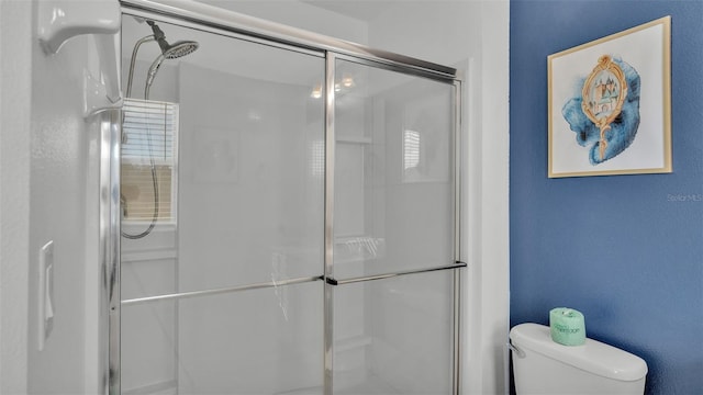 full bath featuring a stall shower and toilet