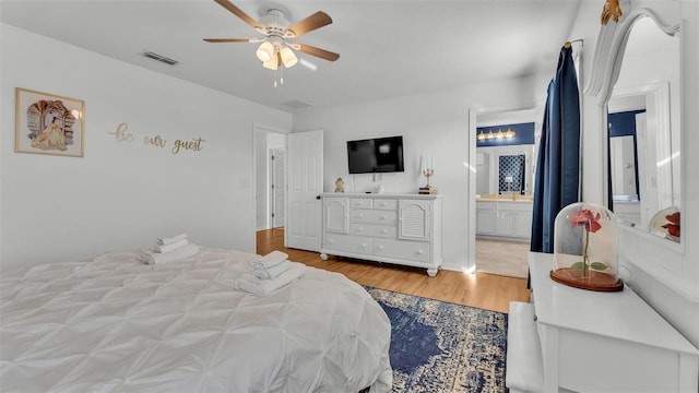 bedroom with connected bathroom, ceiling fan, and light wood-type flooring