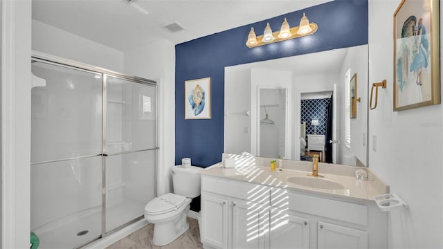 full bathroom with visible vents, a shower stall, toilet, and vanity